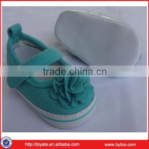 green flower decorating baby shoes