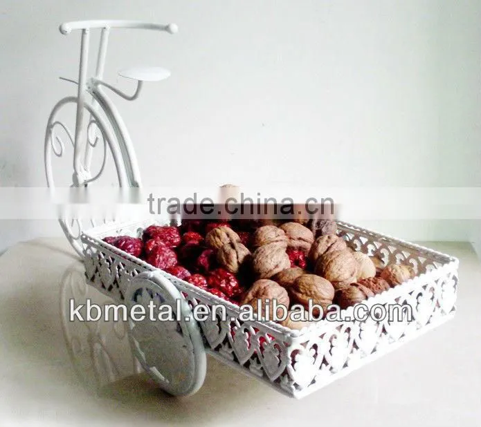 white three-wheel cart fruit plates