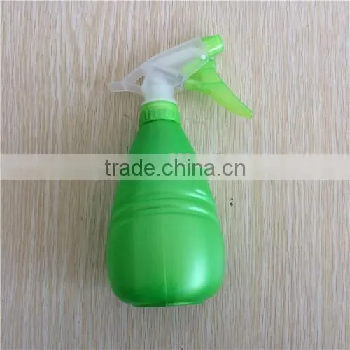 green plastic garden spray bottle with trigger