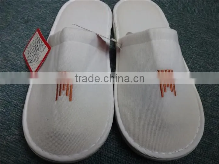 Brand new white fluffy indoor hotel bathroom slippers