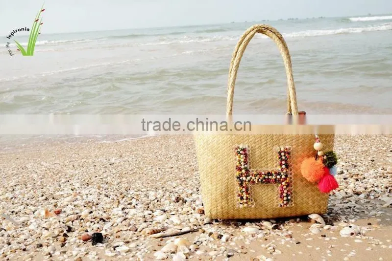 Seagrass beach bag with seashell decoration, cool design for summer holiday