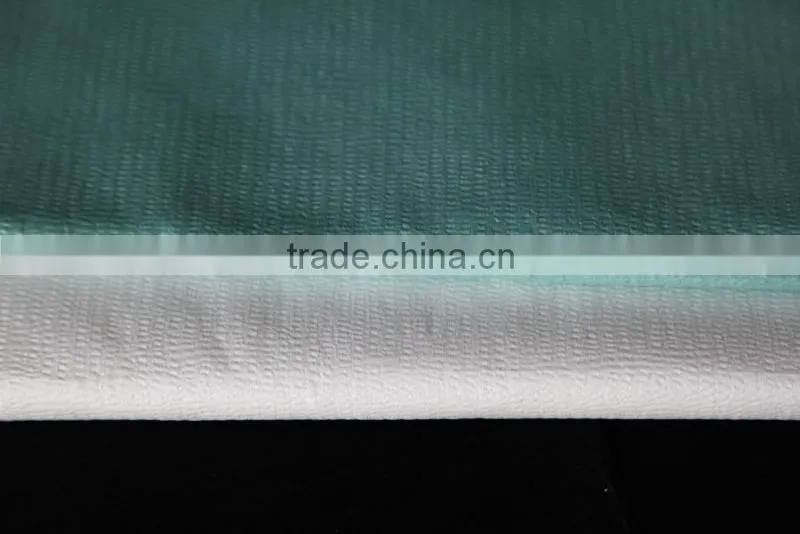 Creped nonwoven spunlace woodpulp polyester