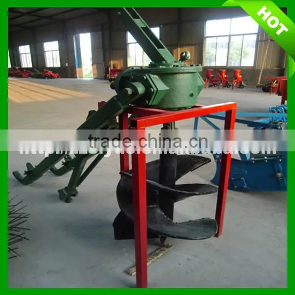 Hydraulic post hole digger mounted on tractor