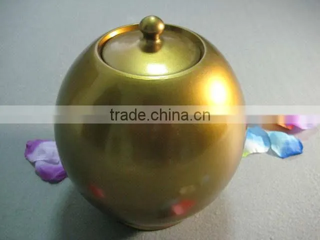 Golden ceramic urns for ashes