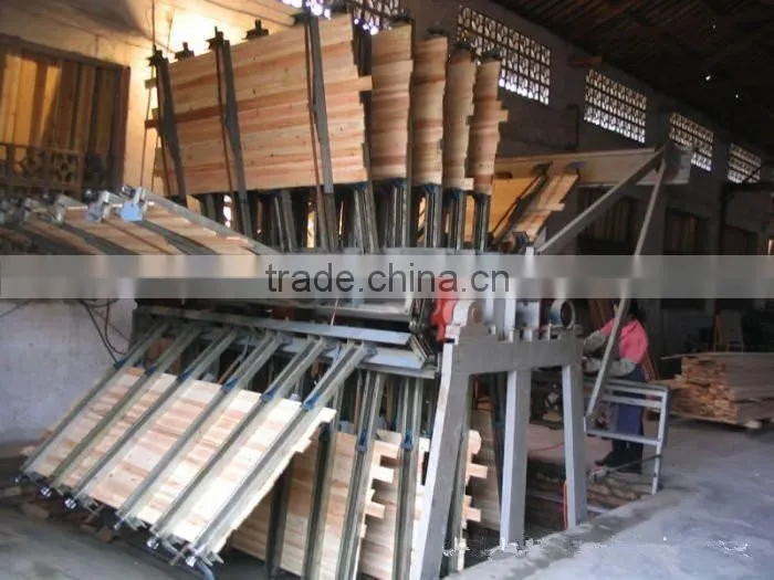 Pneumatic wood composer rotary clamp carrier for wood