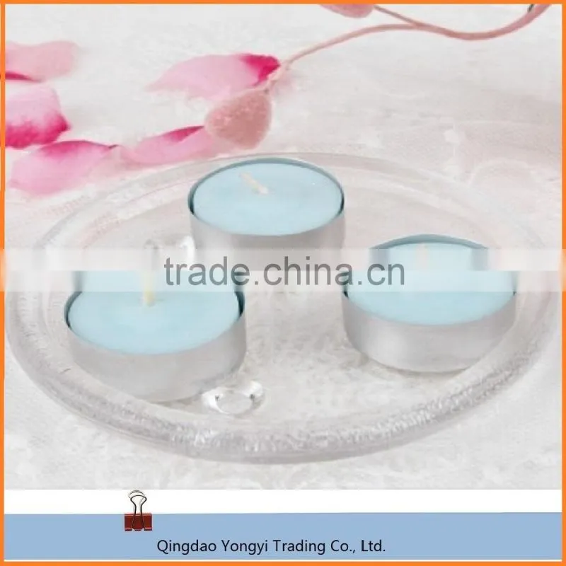 scented and colored tealight candle in plastic cup