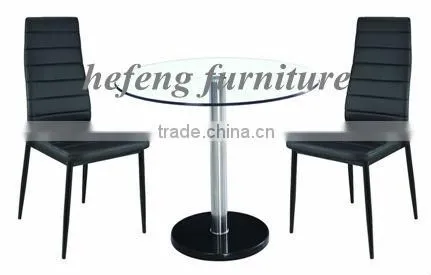Modern round glass dining table with black PVC chair