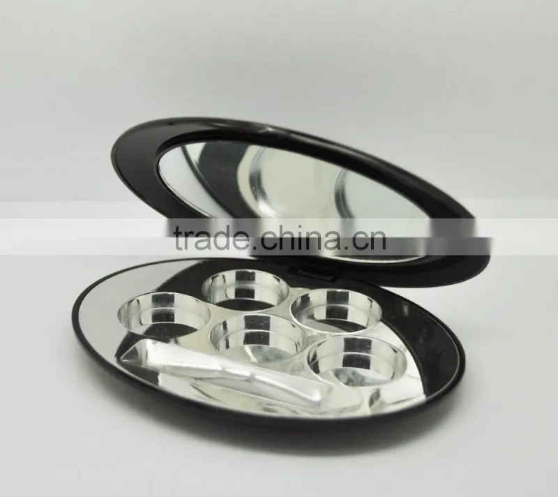 Oval shiny black compact container with shiny silver tray