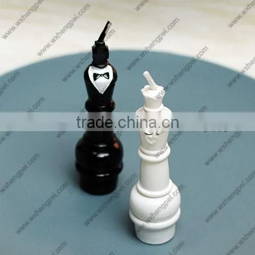 Wedding candles on the chess king and queen