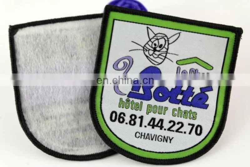 die cut shape with logo book and bird woven military emblems