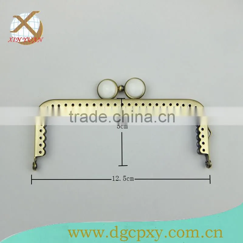 small metal purse frame with whirte gems