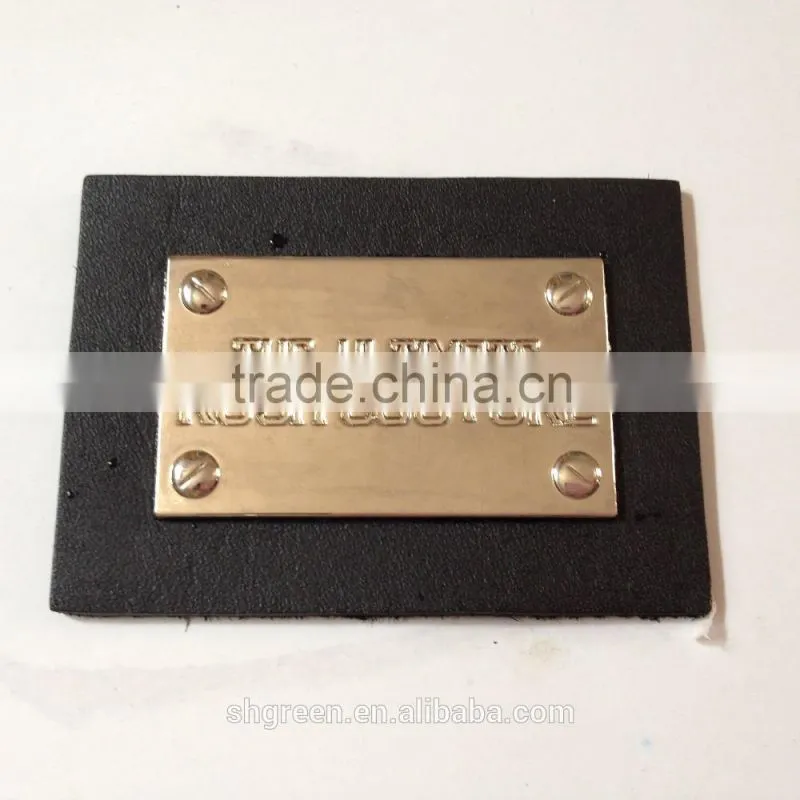 Shiny golden color metal badge on black leather