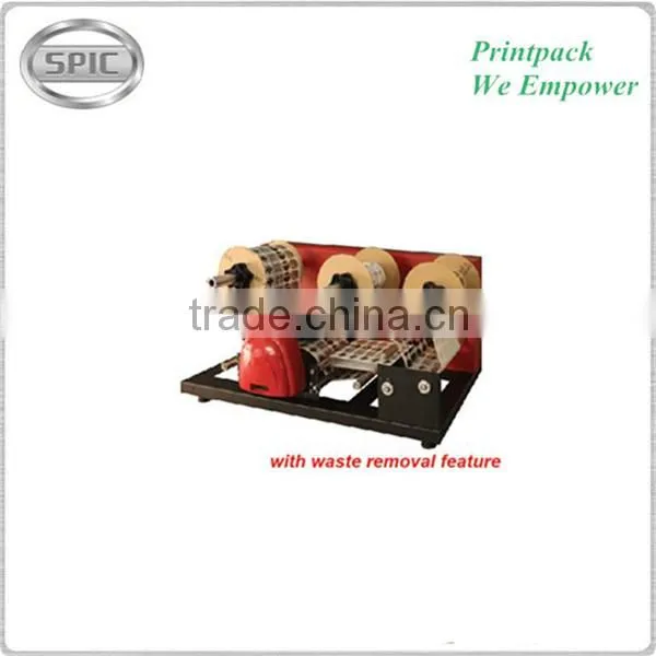 Paper roll die cutting machine with waste removal feature