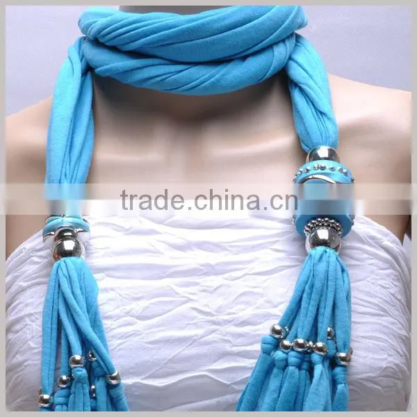 Women adorn article scarf with jewelry