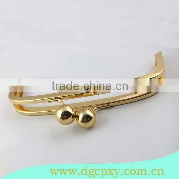 golden metal frame with large ball kiss lock