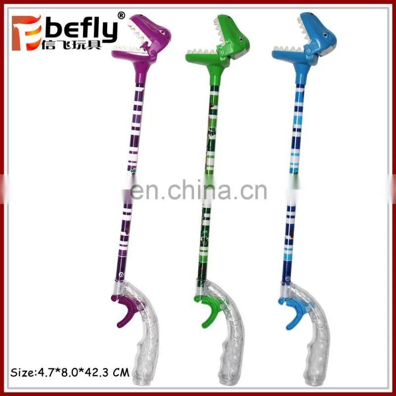 Wholesale funny game plastic dinosaur grabber toy with candy filled
