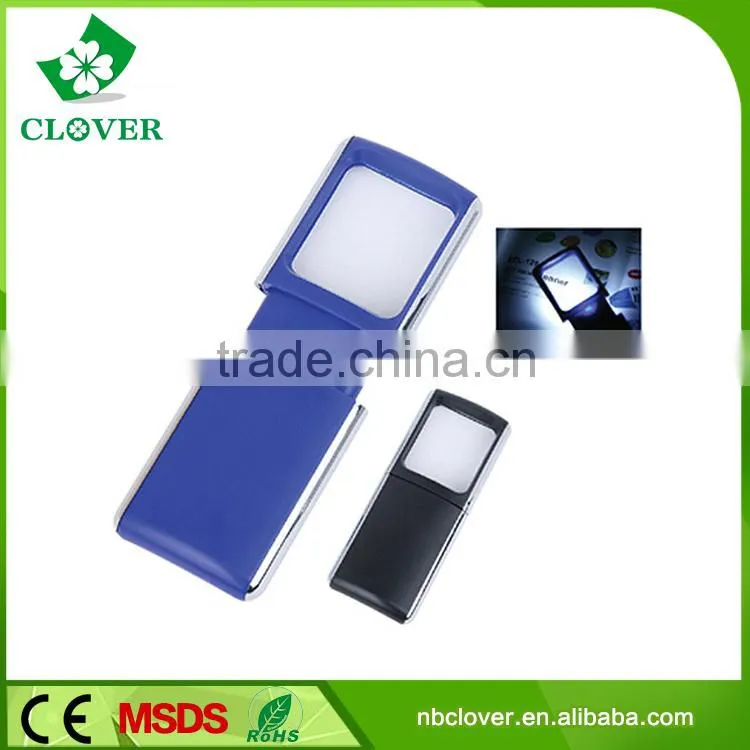 Reading using plastic portable magnifying glass with light