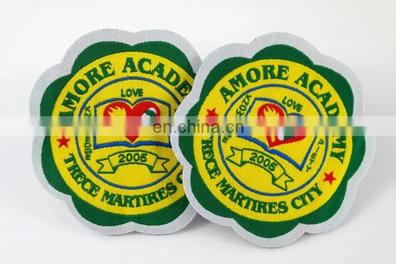 die cut shape with logo book and bird woven military emblems