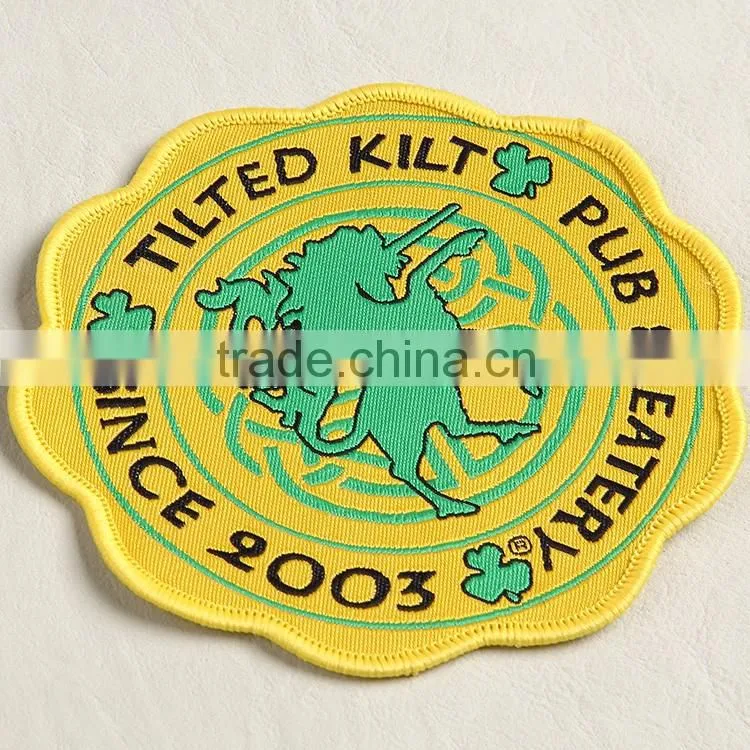Professionally supply woven over locked fabric tag with light yellow base for patterned blouse