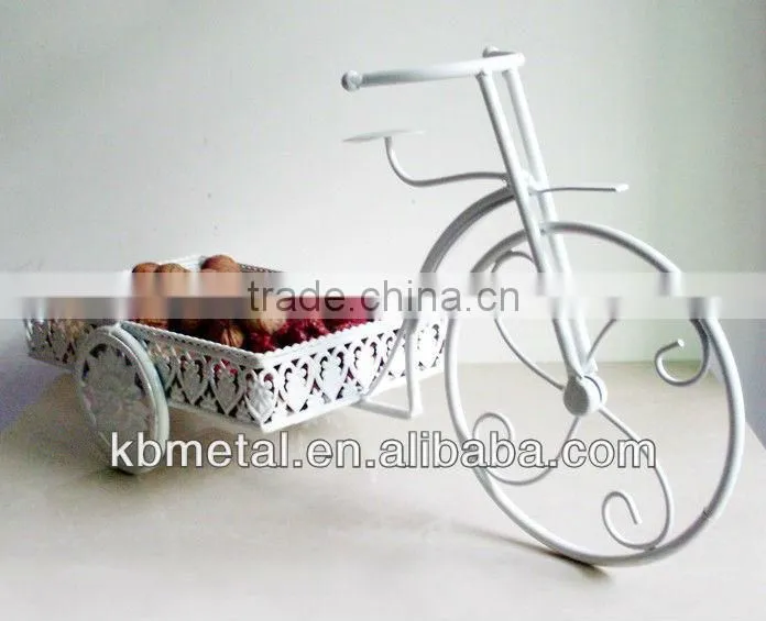white three-wheel cart fruit plates