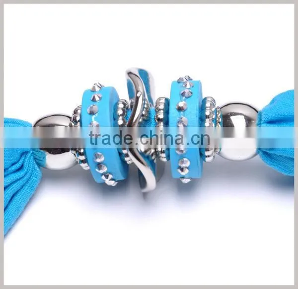 Women adorn article scarf with jewelry