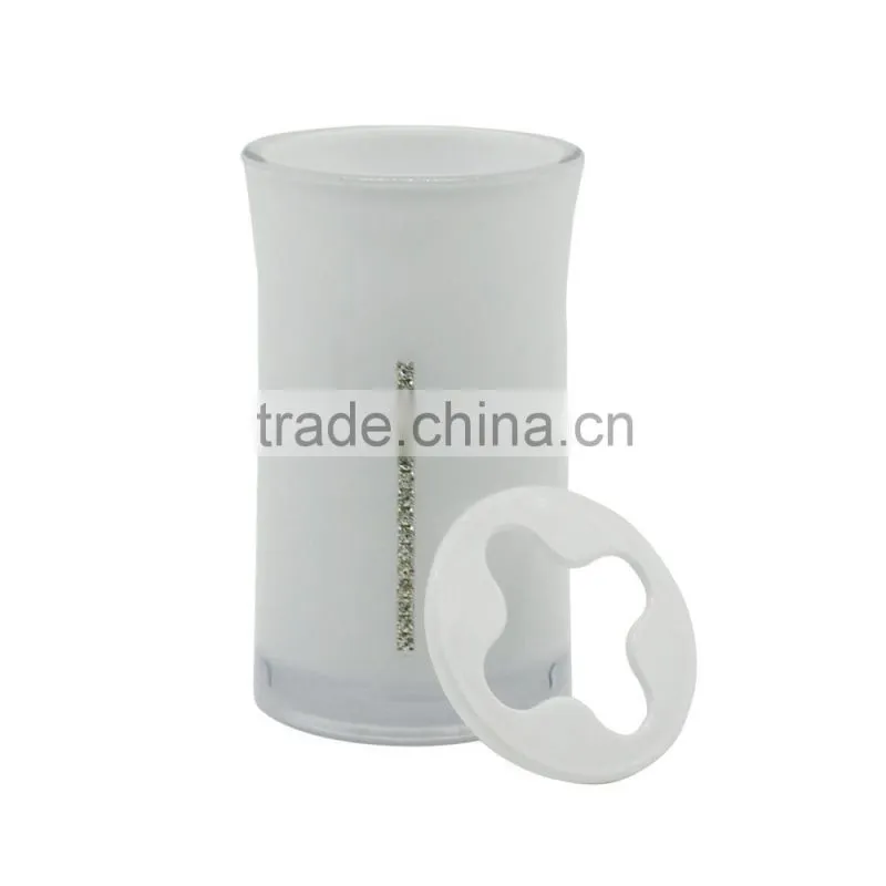 white toothpaste and toothbrush holder