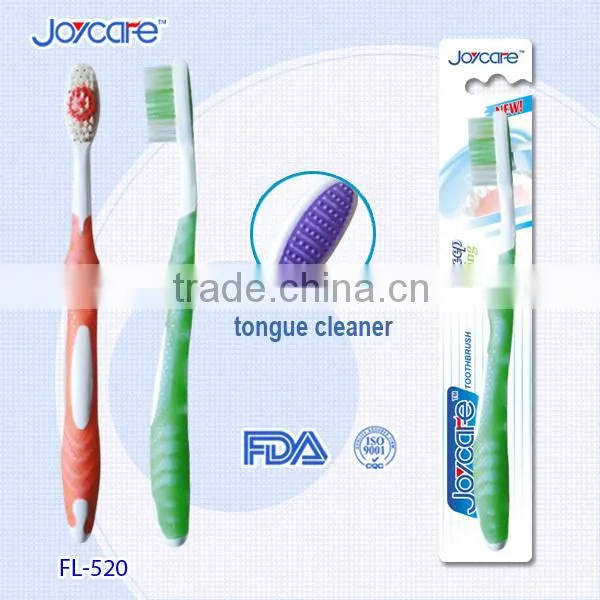 Oral care toothbrush with tongue cleaner