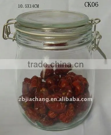 Clear glass food storage bottle with metal clip