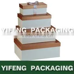 white nested cardboard boxes with ribbon design