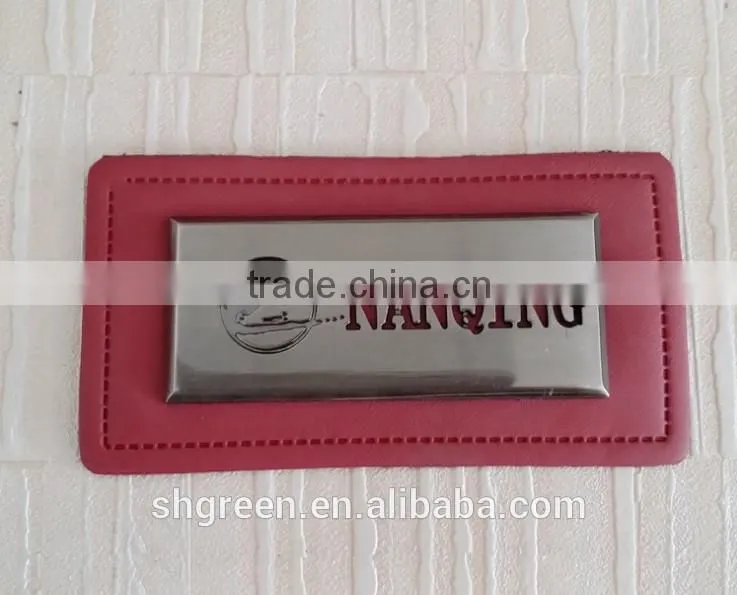 Embossed leather patch with metal logo for lady's handbag