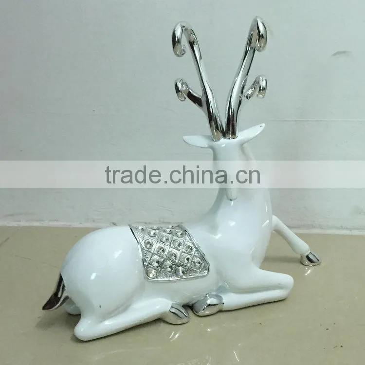 Polyresin sitting reindeer sculpture