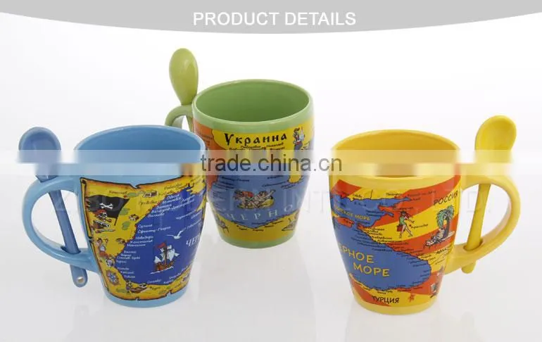 coloured ceramic coffee mug with design printing and spoon in handle