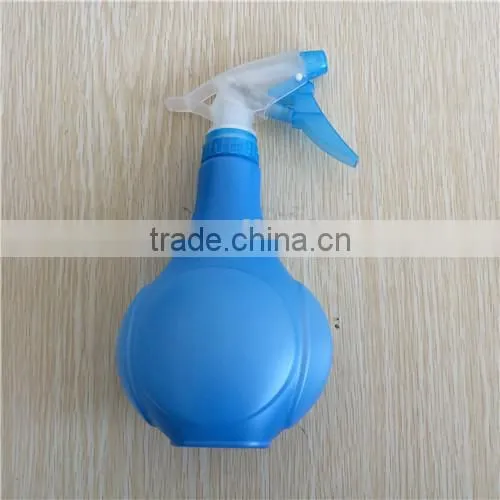 blue plastic garden spray bottle with trigger