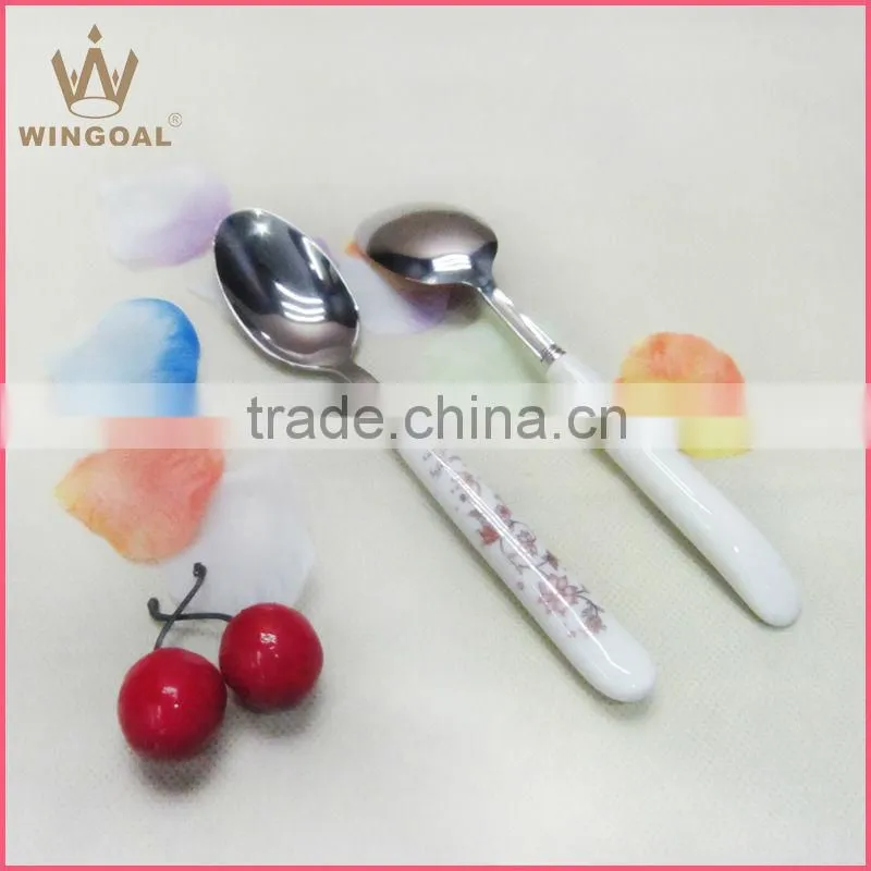 Stainless spoon with porcelain handle