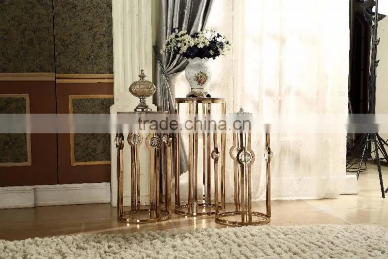 Golden color metal flower stand pergola with marble top