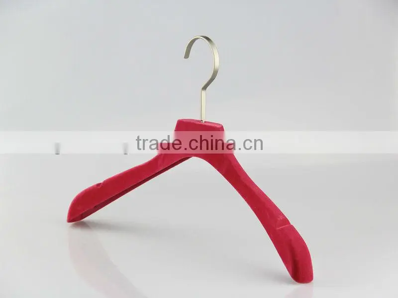 Pink velvet dress hanger with gold stamped logo