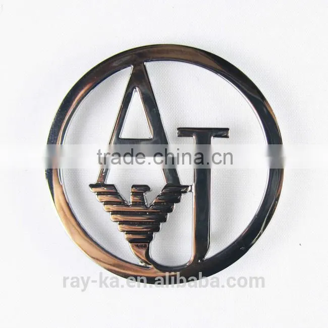 designer metal emblems handbag