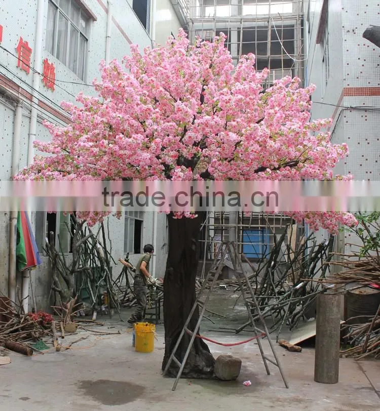 Pink artificial cherry blossom trees with rotating base
