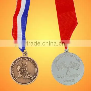 Golden badge/lapel pin/medal with green ribbon