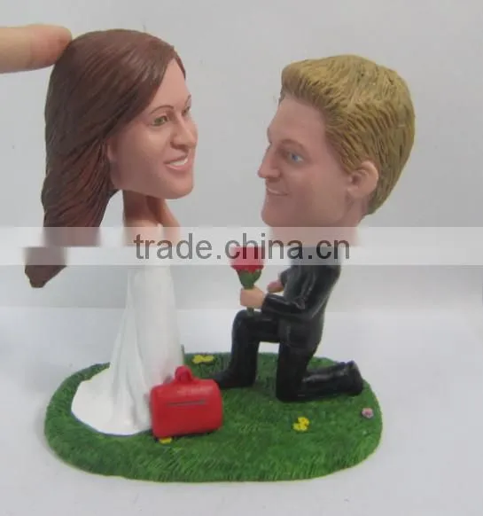 groom make a proposal of marrie to bride figurine