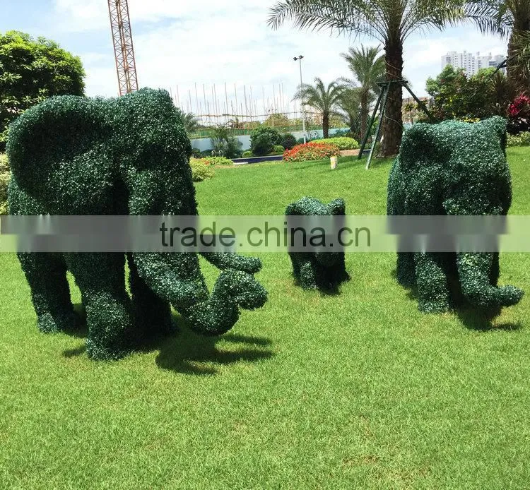 Green grass elephant statue