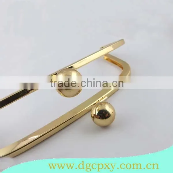 golden metal frame with large ball kiss lock