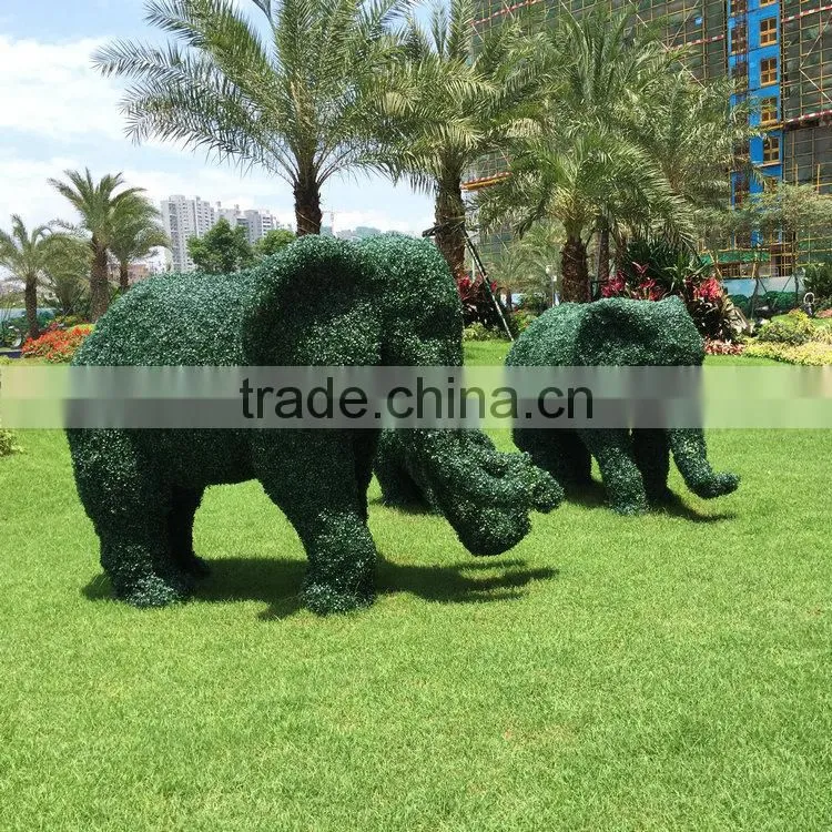 Green grass elephant statue