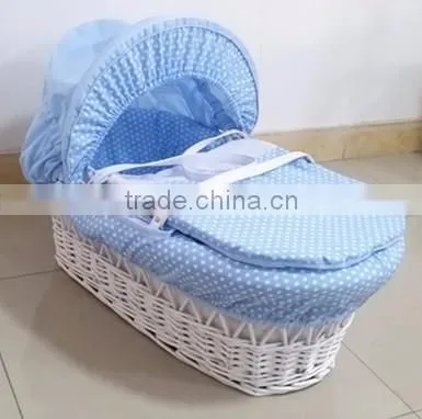 White wicker baby bassinet with cosy dressings