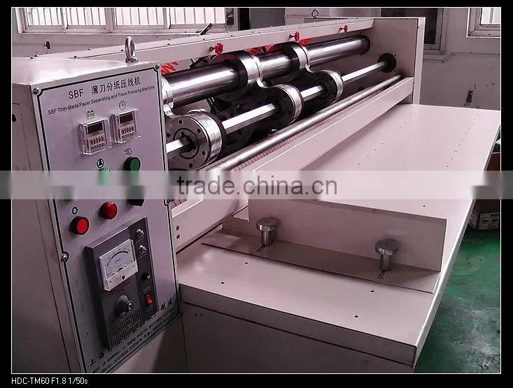 Automatic corrugated paperboard slitting scorer