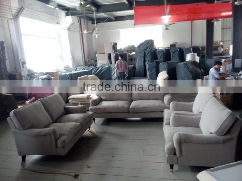 beige linen sofa with metal rolling castor