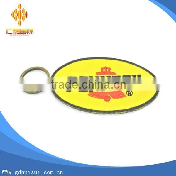 Popular design cheap customized elliptical shape embroidery personalized logo key chain