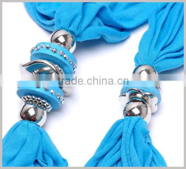 Women adorn article scarf with jewelry