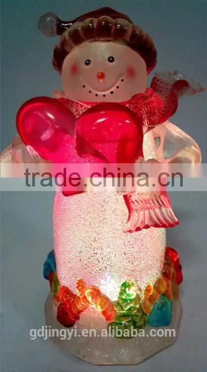 Holding a red heart acrylic snowman with LED Light