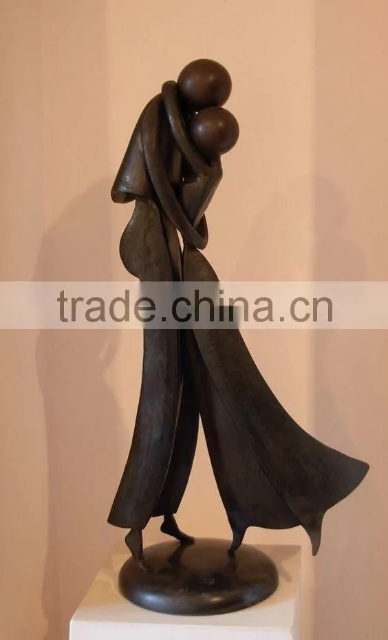 a couple locked in an embrace bronze indoor sculpture